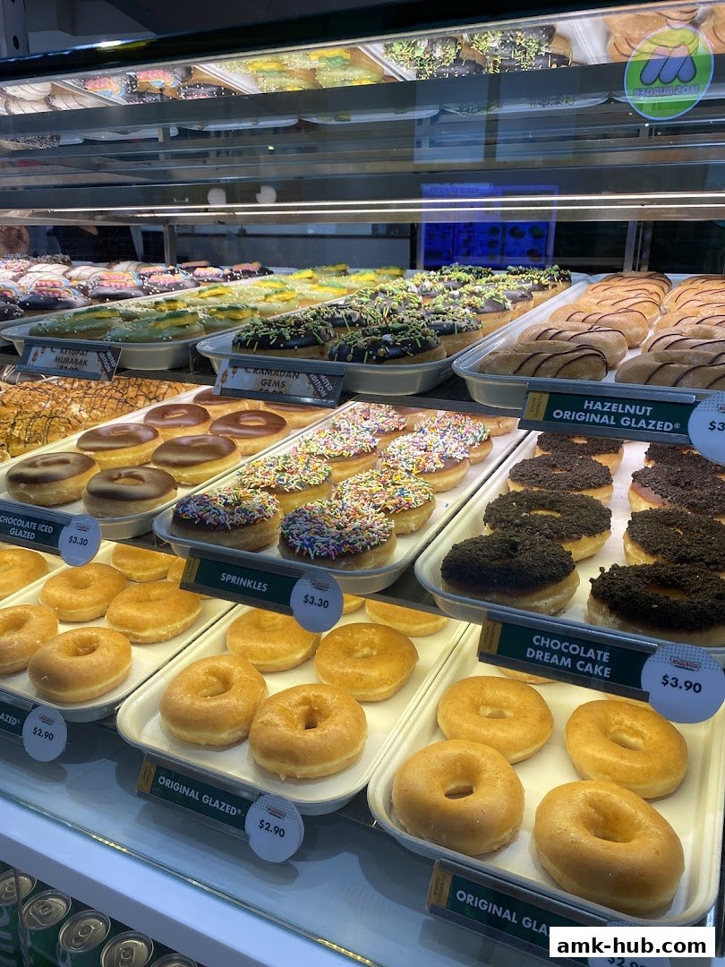 A display case filled with a variety of colorful and glazed donuts.
