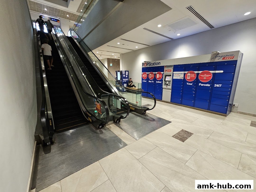 POPStation parcel lockers and escalators in a modern shopping mall.