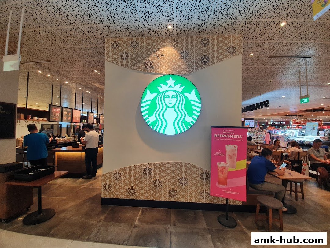Interior view of a Starbucks coffee shop with customers and staff.