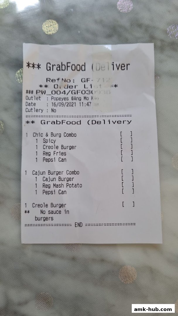 A receipt from GrabFood for Popeyes Ang Mo Kio Hub showing a food order.