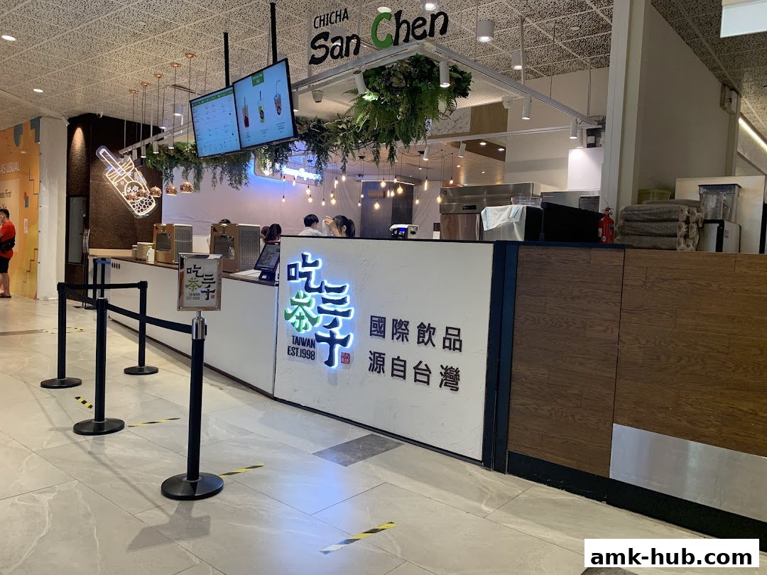 The interior of a CHICHA San Chen bubble tea shop with a counter and signage.