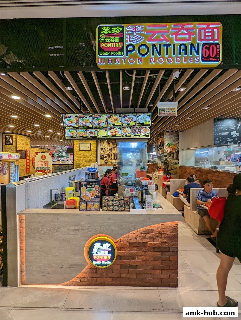 The exterior of Pontian Wanton Noodles shop with a prominent sign and display of food.