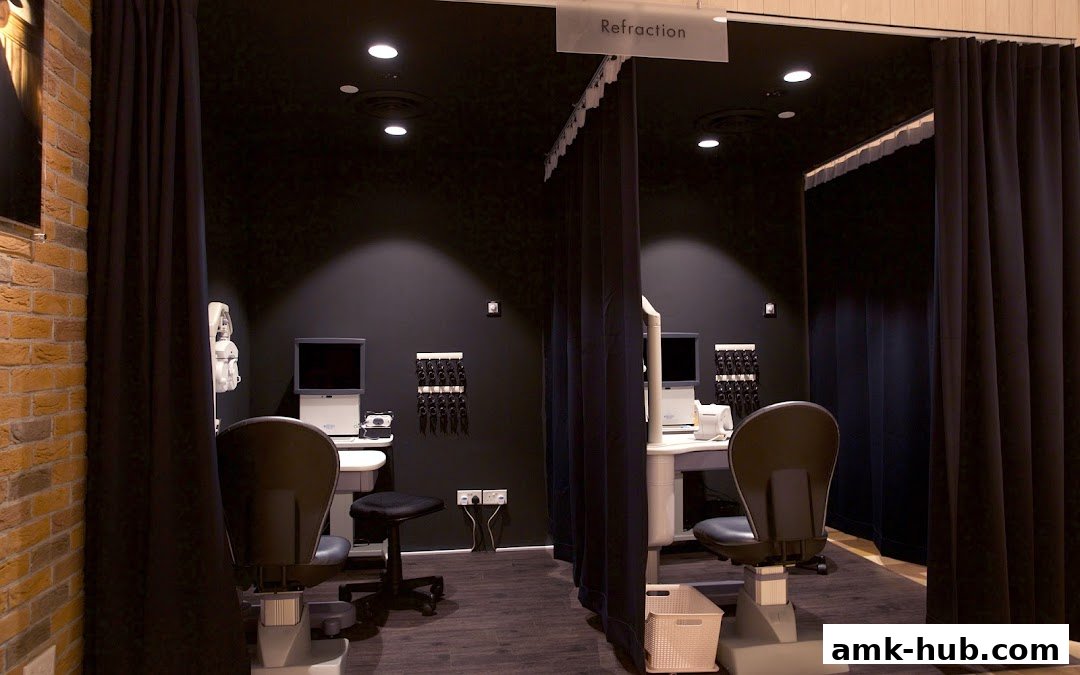 Interior view of two eye examination rooms with chairs and equipment at OWNDAYS AMK Hub.