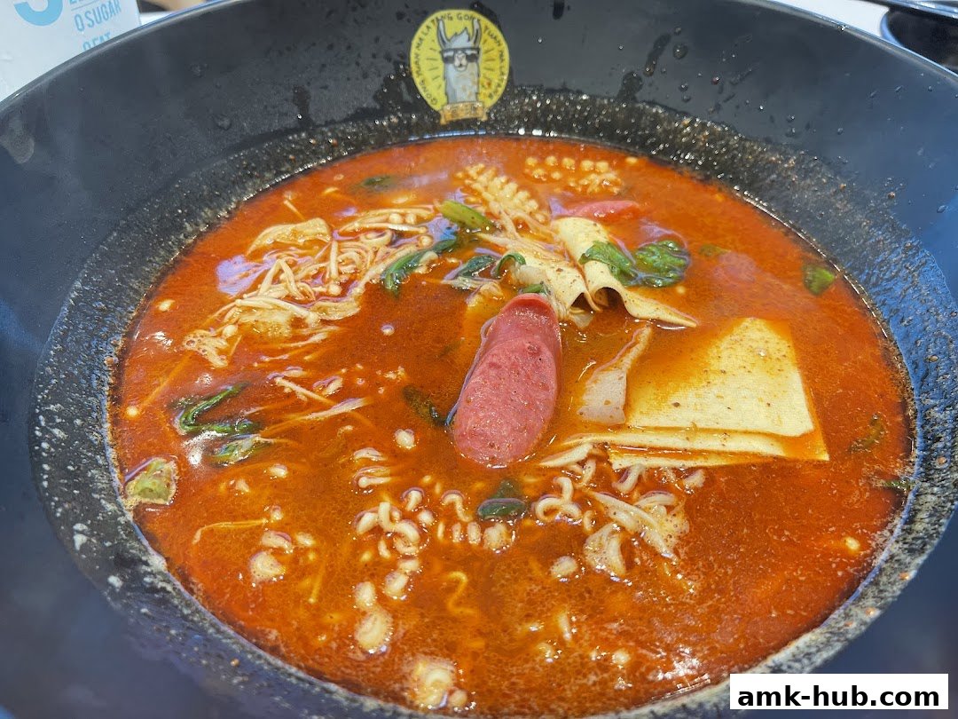 A close-up of a steaming bowl of Mala Tang with various ingredients in a rich broth.
