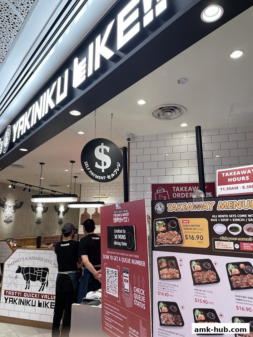 The entrance of Yakiniku Like AMK Hub with a takeaway menu and queue information.