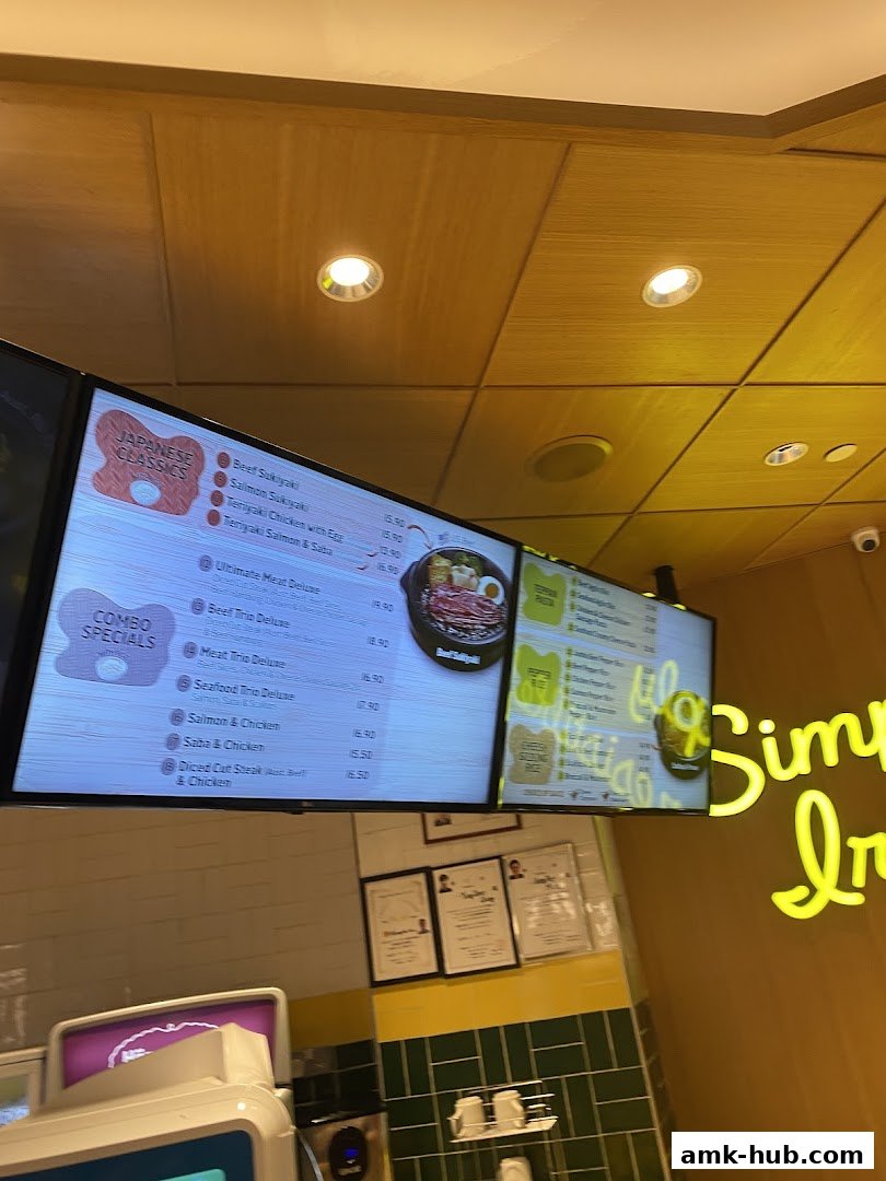 A digital menu board displaying Japanese classics and combo specials with prices.