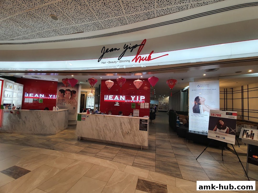 The entrance of Jean Yip Beauty AMK Hub, showcasing its reception area and promotional posters.