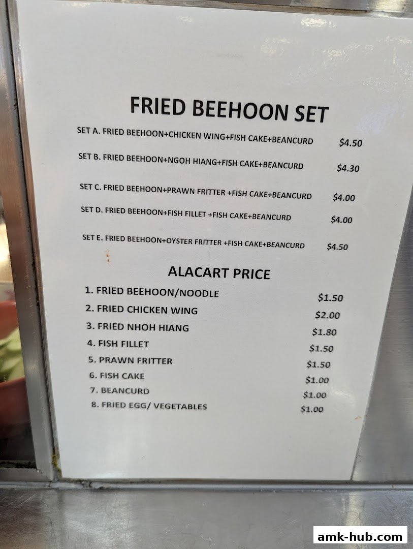 A menu board displays fried beehoon sets and a la carte prices for various food items.