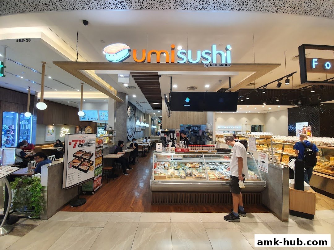Umisushi shop interior with display cases of sushi and customers dining.