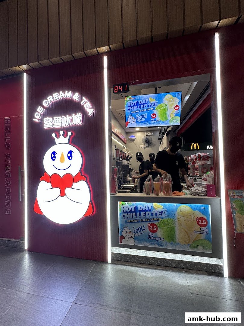 A brightly lit MIXUE Ice Cream & Tea shop with its signature snowman logo and promotional displays.