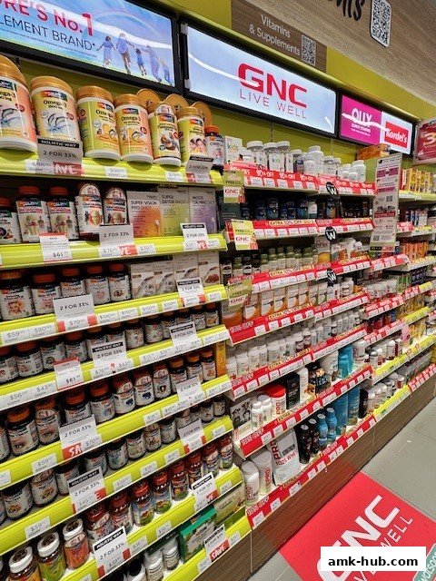 Shelves stocked with various vitamins, supplements, and health products at GNC.