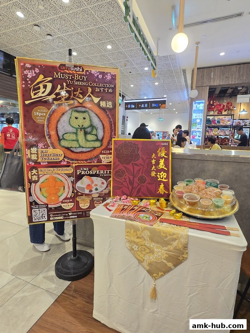 A display table with a Yu Sheng promotion and sushi items from Umisushi.