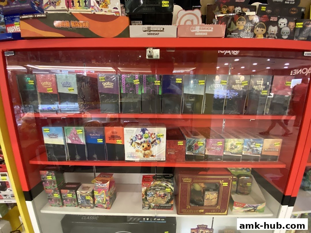 A display cabinet filled with various trading card game booster boxes and collectible items.