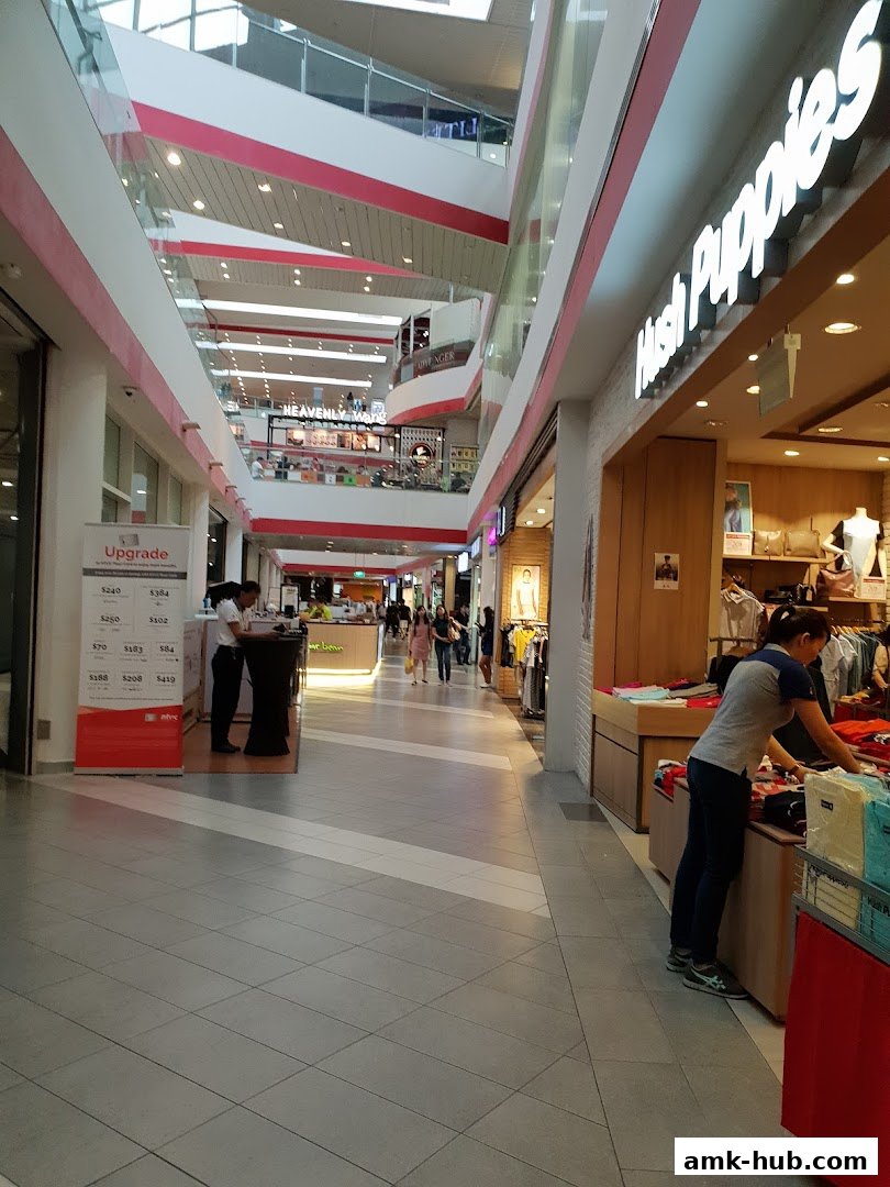 A view of a shopping mall corridor with the Hush Puppies store visible.