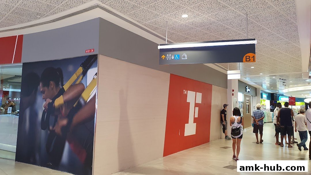Fitness First gym entrance with large promotional graphics and mall signage.