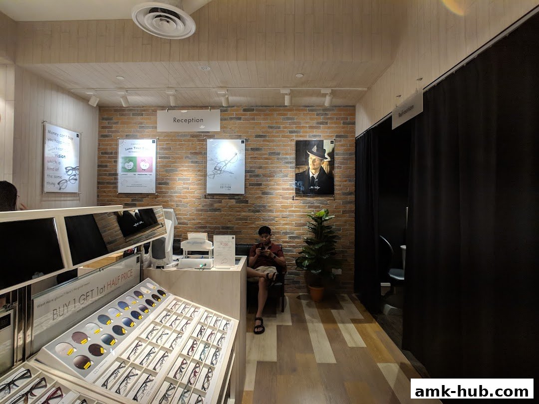 Interior of an optical shop with displays of glasses and a reception area.