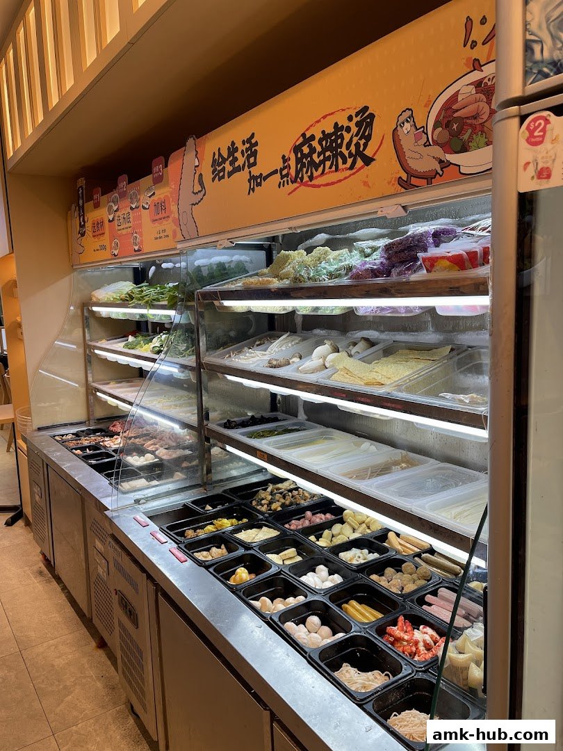 A display of fresh ingredients for Mala Tang, including vegetables, meats, and seafood.
