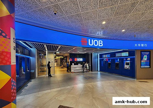 The modern entrance of a UOB bank branch with ATMs and customer service counters.