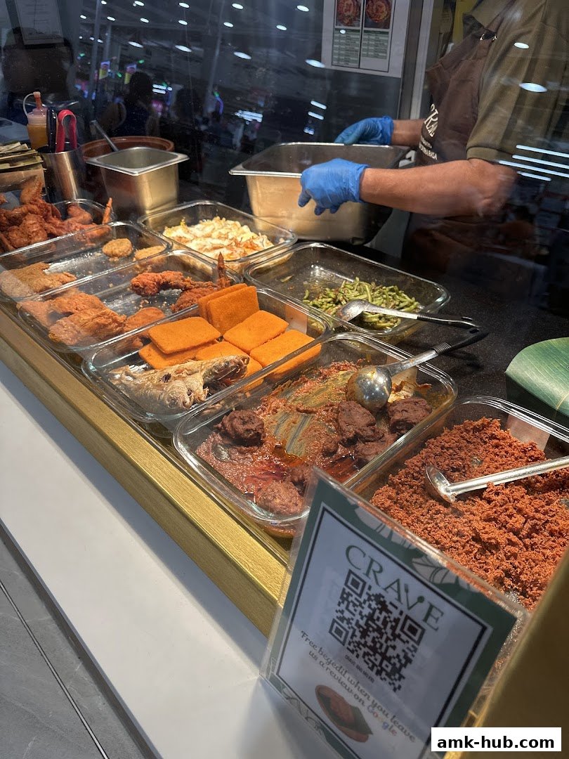 A display of various Nasi Lemak dishes and fried items at Crave.