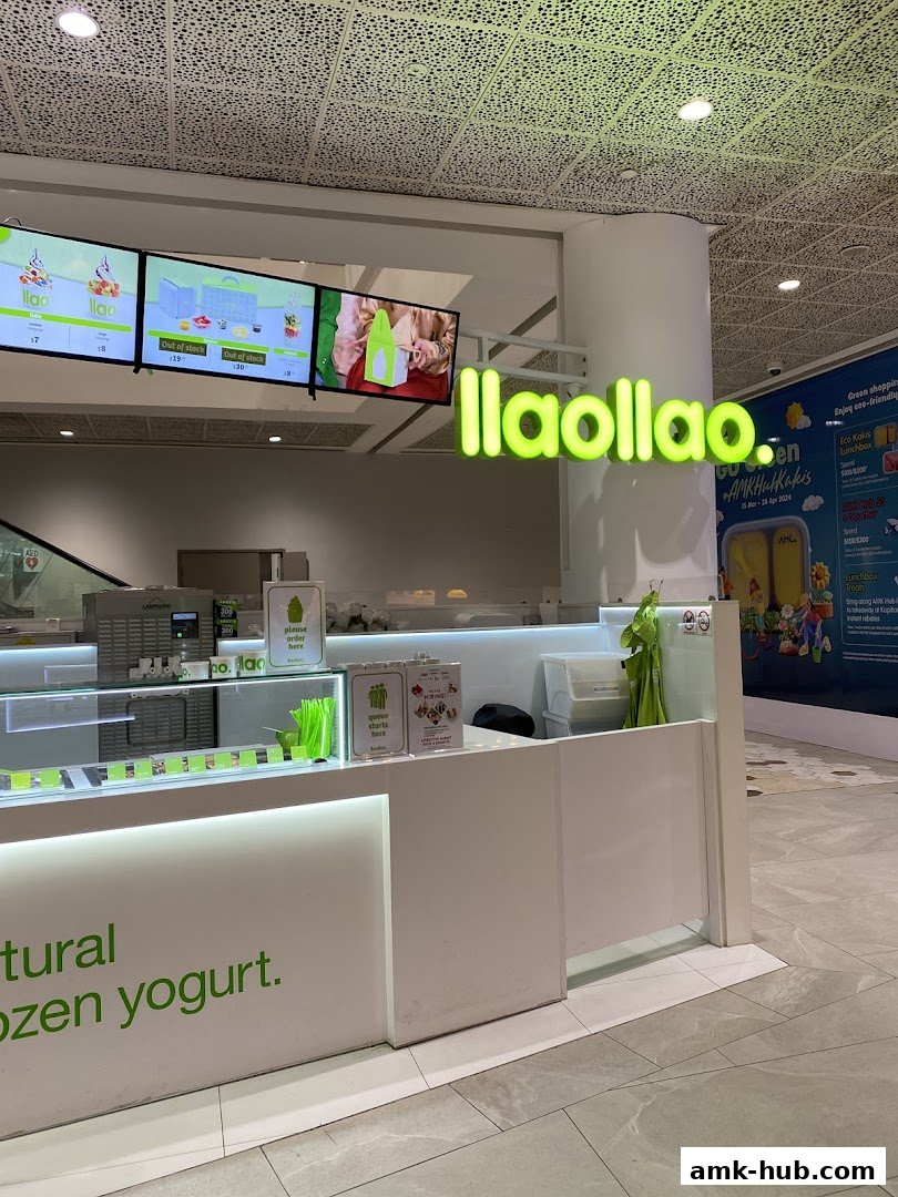 The llaollao frozen yogurt shop front with illuminated signage and digital menu boards.