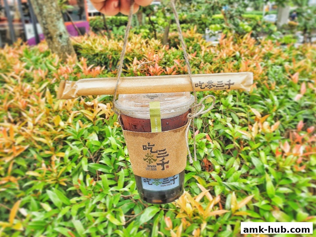 A person holds a cup of iced tea from CHICHA San Chen with a bamboo straw.