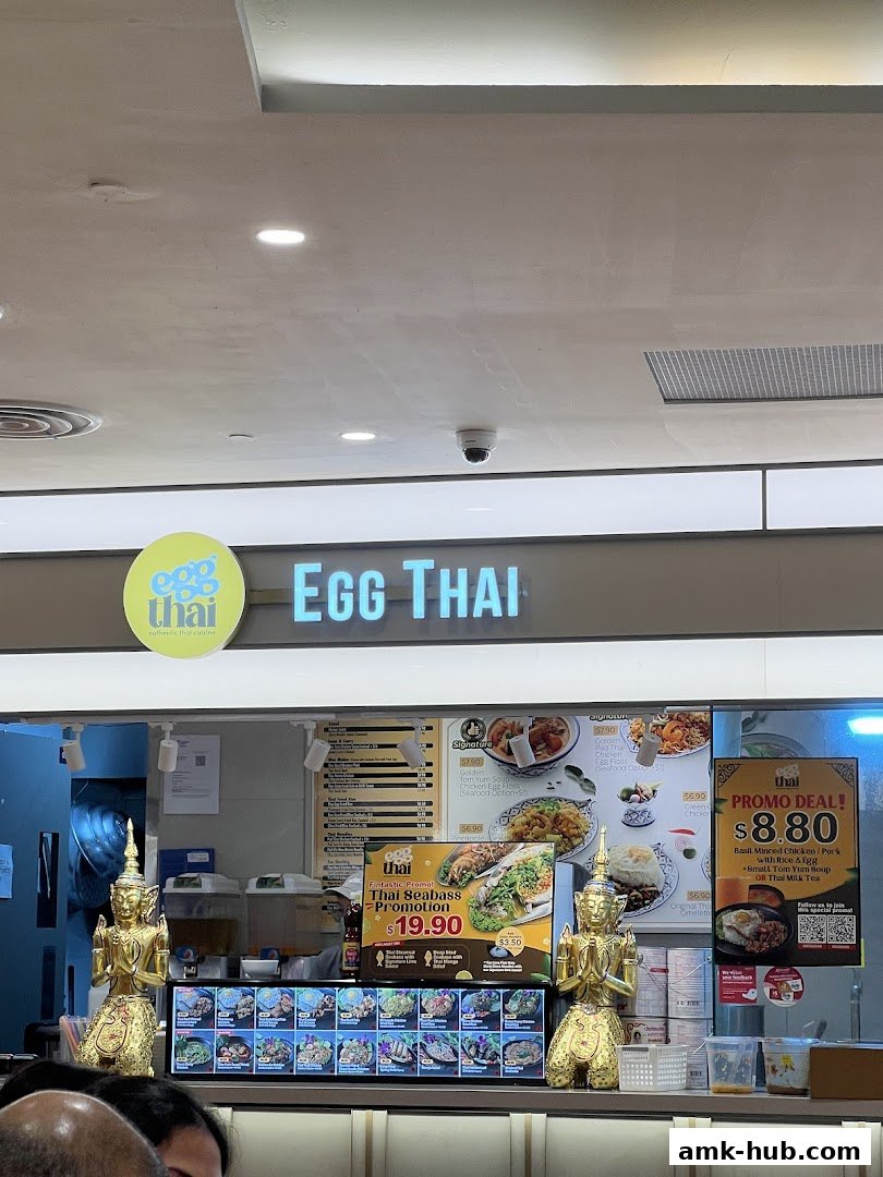 The Egg Thai restaurant storefront with a menu and promotional displays.