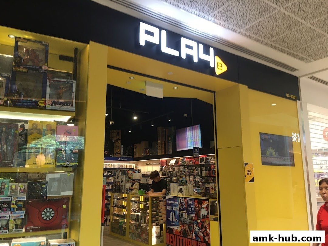 The entrance of PLAYe, a store selling video games and collectibles, with merchandise displayed in the windows.