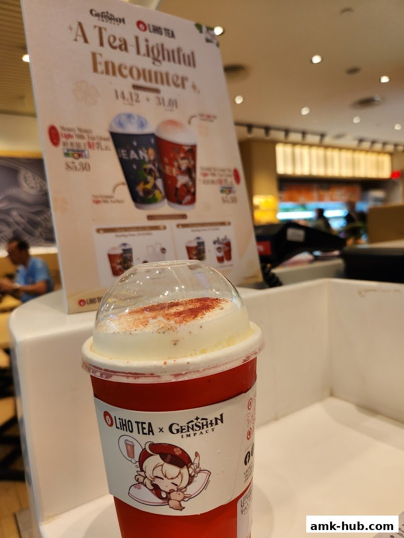 A LiHO TEA cup with Genshin Impact branding and a promotional poster in the background.