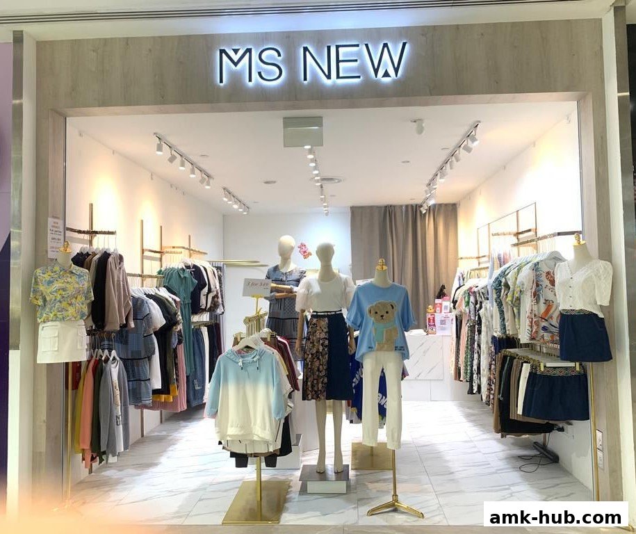 The entrance of a clothing store named 'MS NEW' displaying mannequins and apparel.