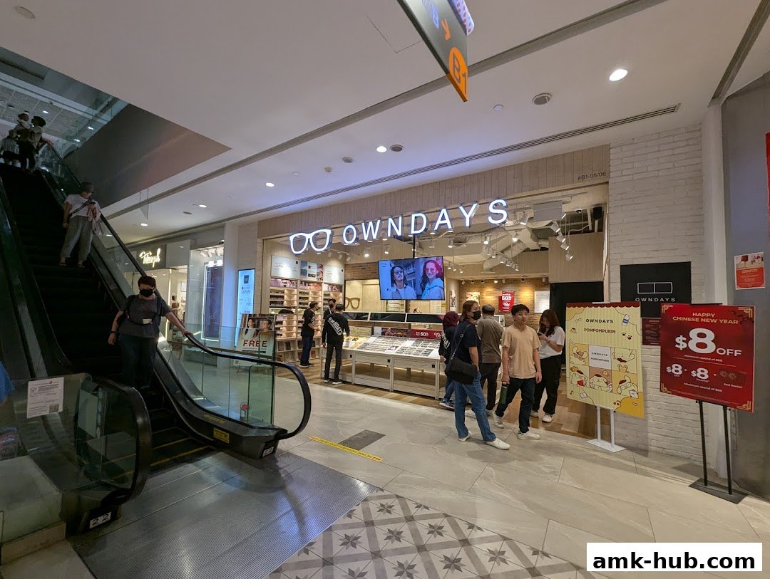 People near the OWNDAYS optical shop entrance with displays of glasses and promotional signs.