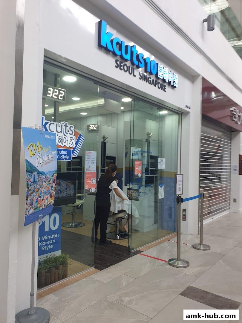 The exterior of a kcuts hair salon with a stylist cutting a customer's hair.
