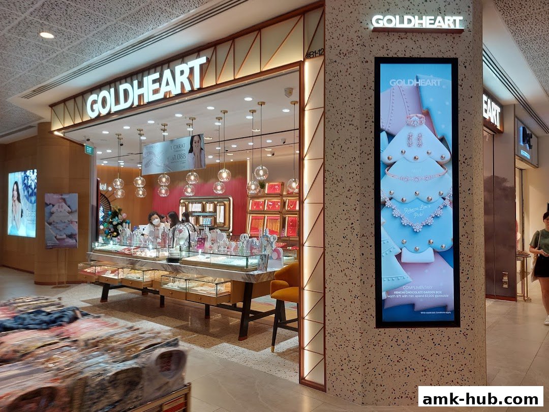 The Goldheart Jewelry store entrance with displays of jewelry and a digital advertisement.