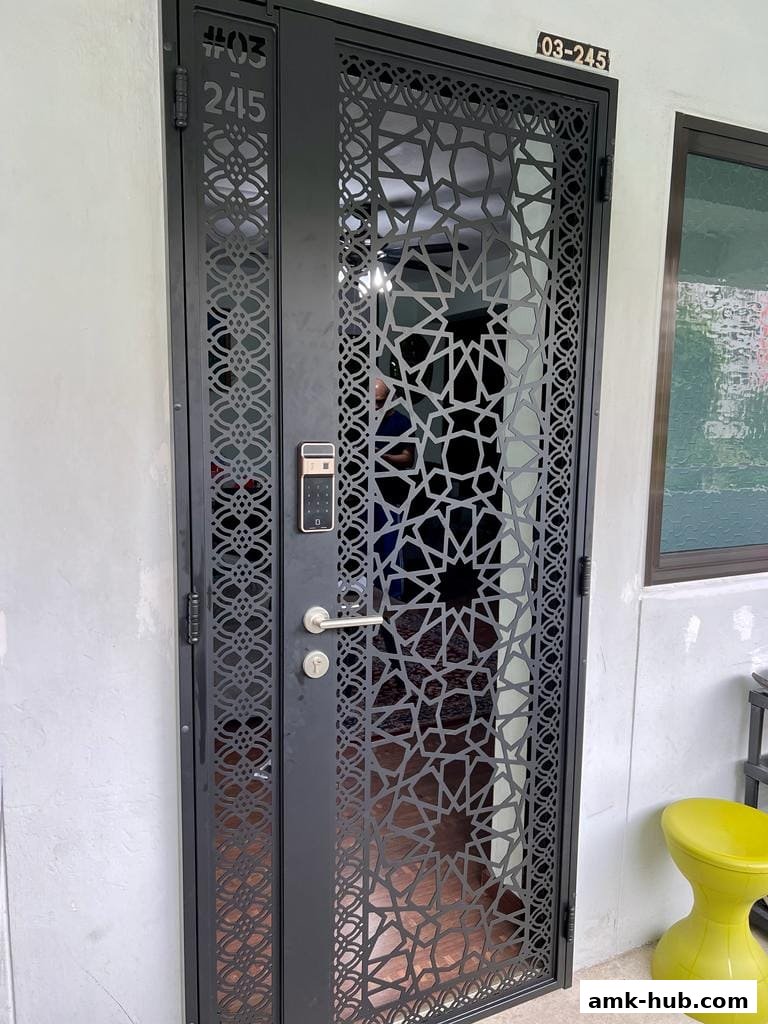 A modern black metal gate with intricate geometric patterns and a digital lock.