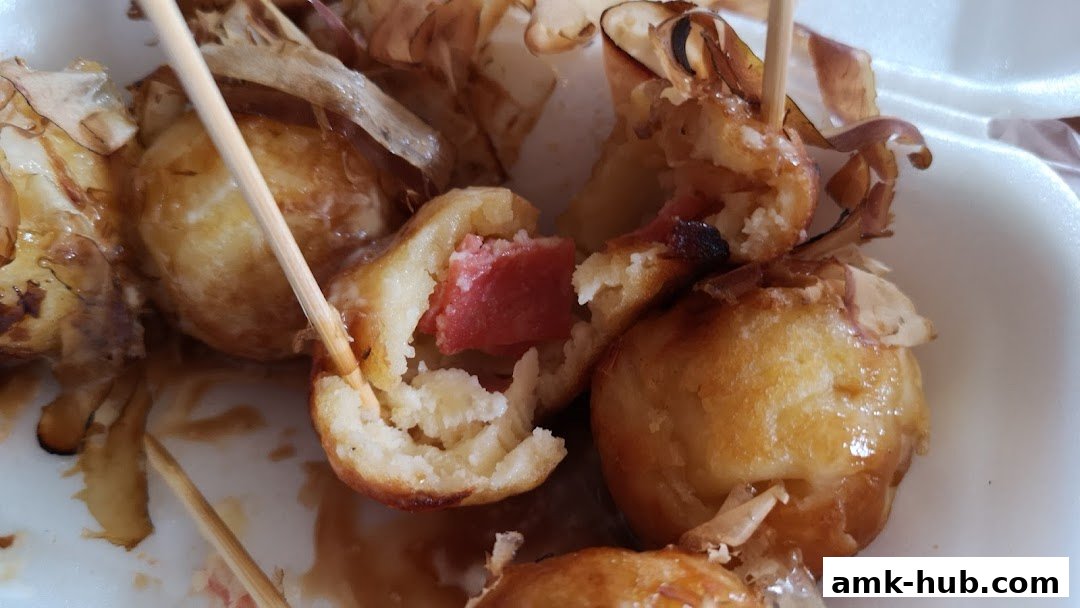 Close-up of delicious takoyaki with a savory sauce and bonito flakes.