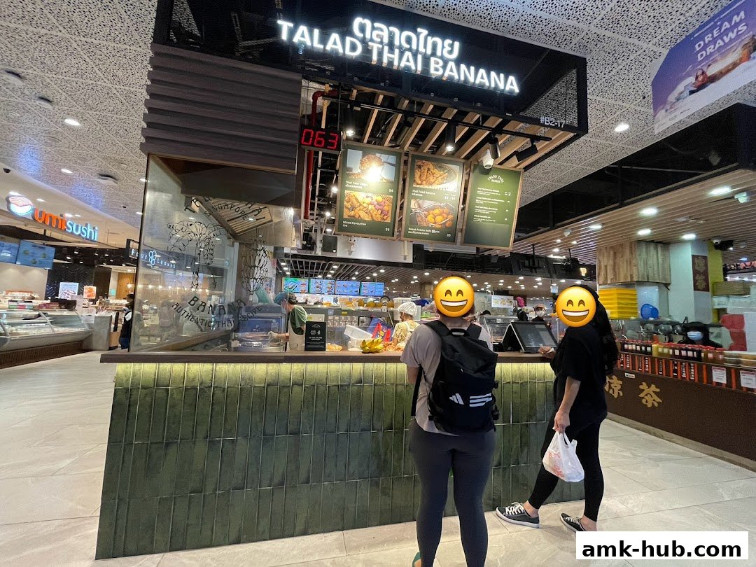 A food stall named Talad Thai Banana with customers ordering food.