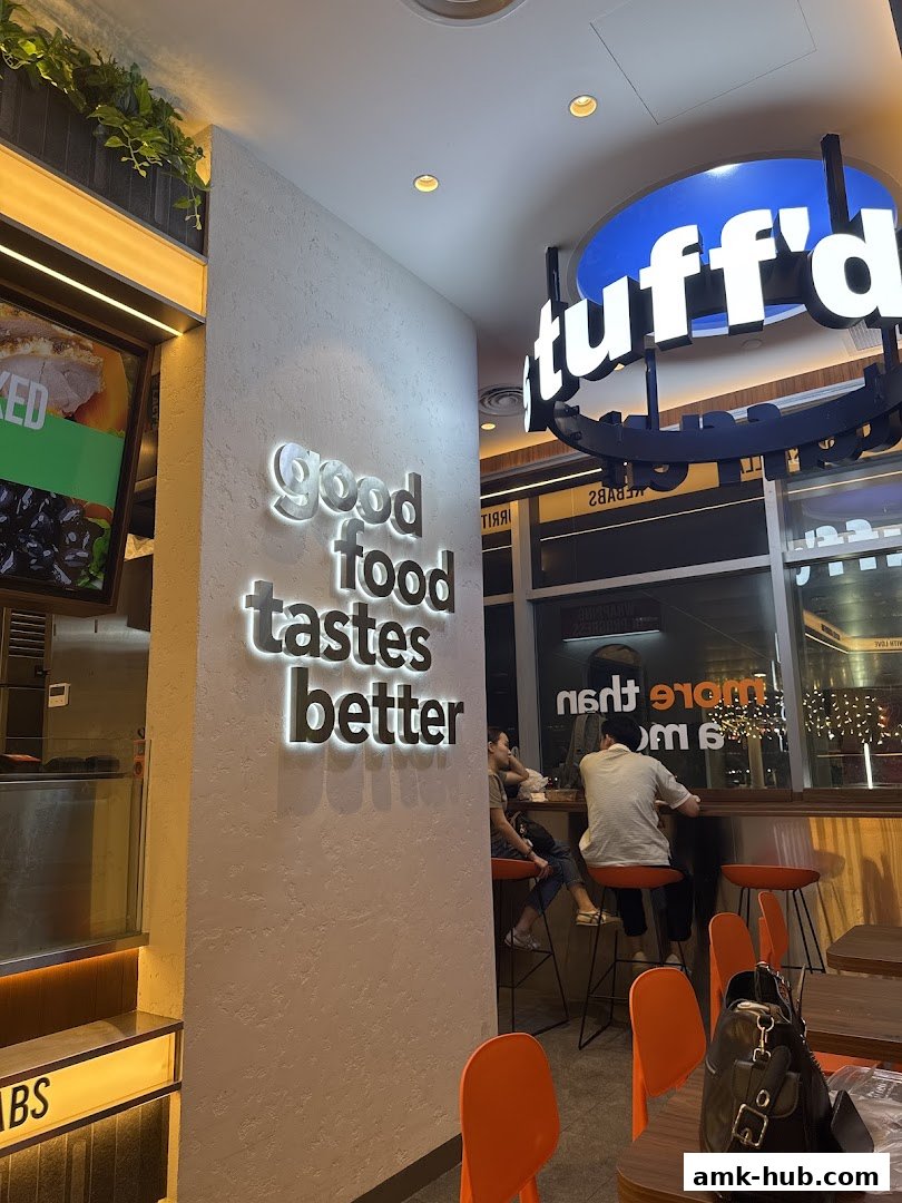 Interior shot of Stuffd More with illuminated signage and seating area.