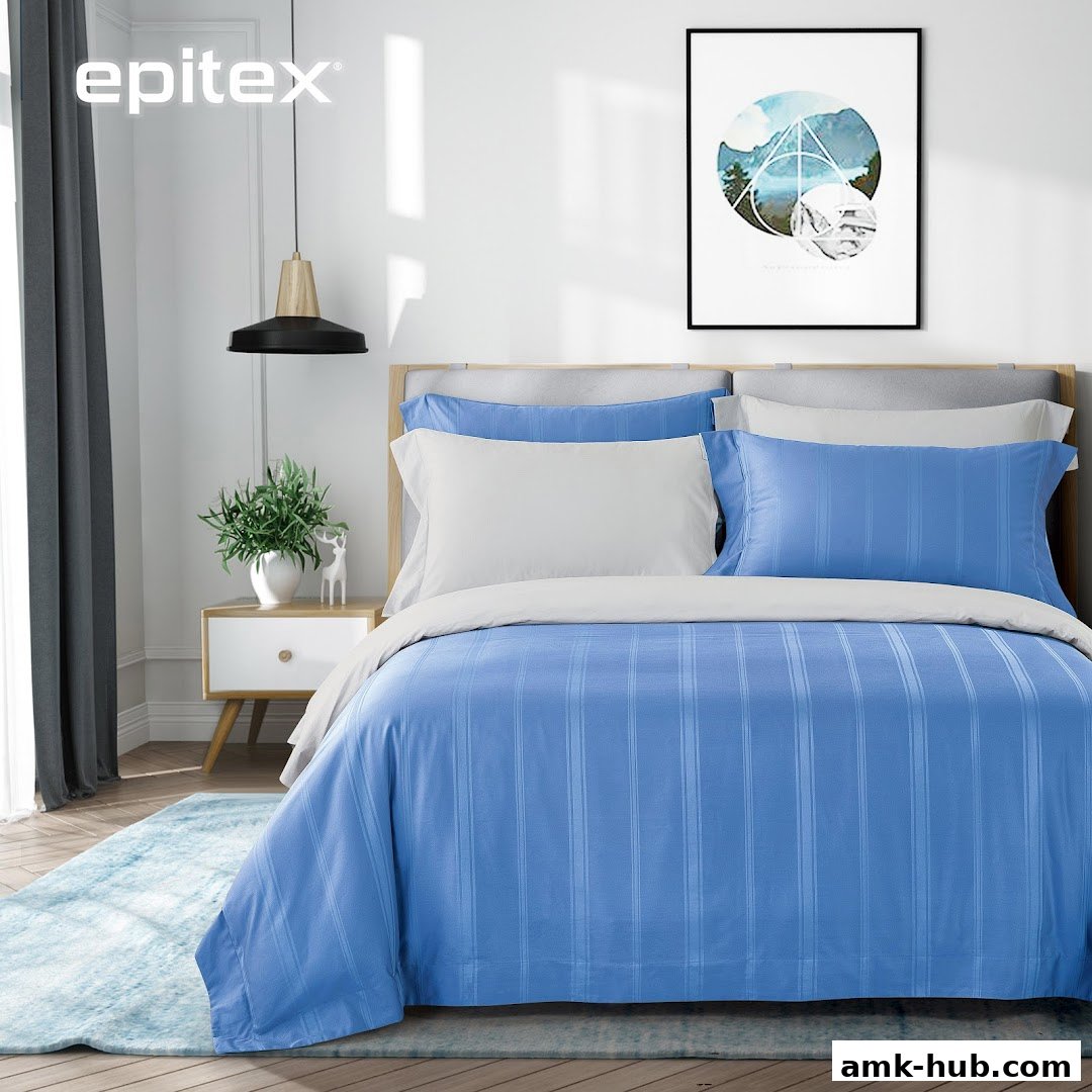 A beautifully made bed with blue striped bedding and white pillows, styled in a modern bedroom.