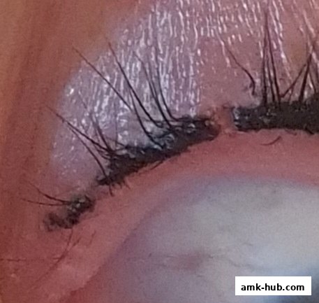 Close-up of a person's eye with makeup and eyelashes.