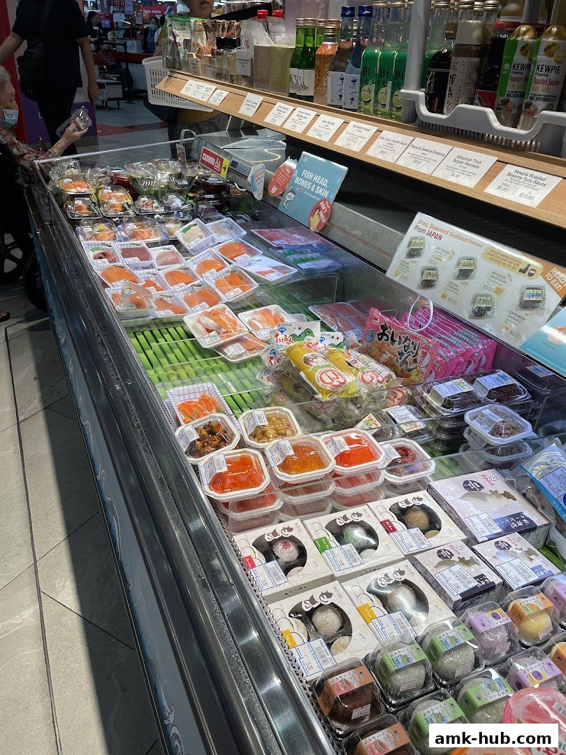 A display of fresh sushi, seafood, and Japanese snacks at Kuriya Japanese Market.