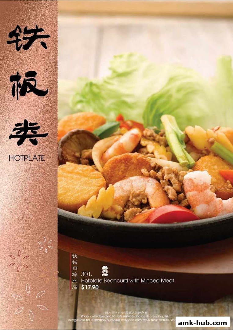 A close-up of a hotplate dish with beancurd, minced meat, and shrimp.