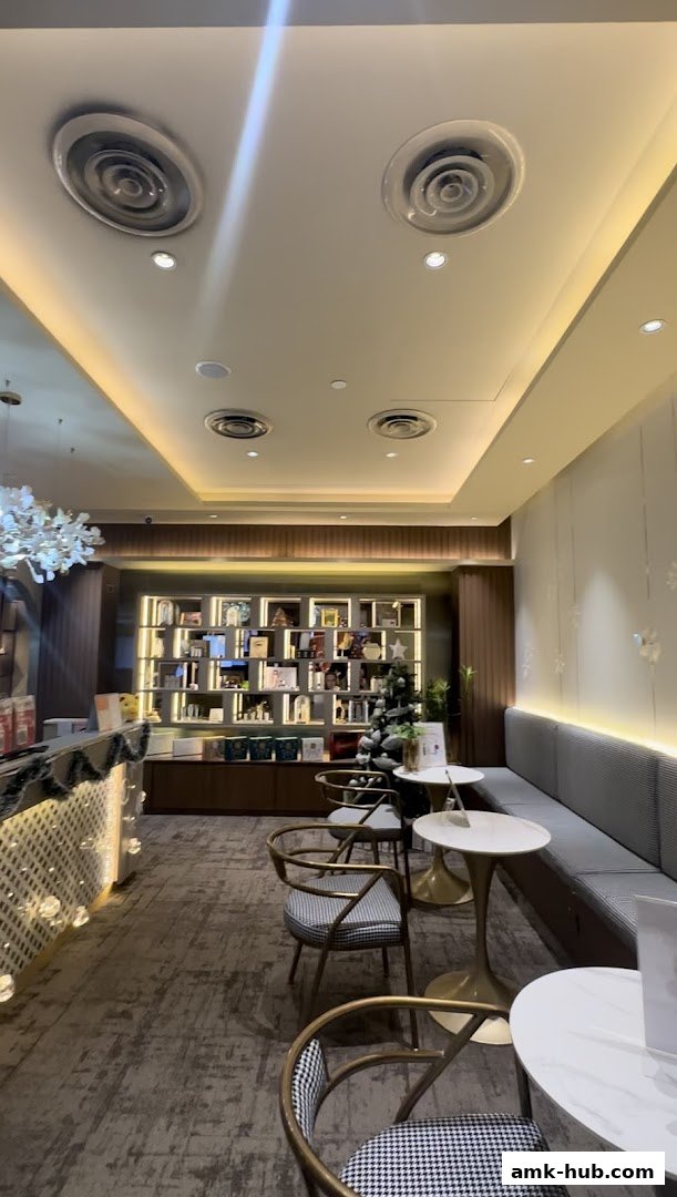 Interior of a beauty shop with shelves of products, seating area, and decorative elements.