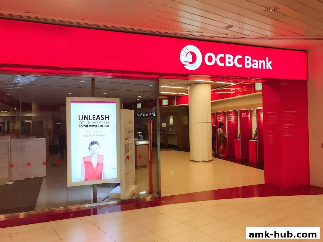 The entrance of OCBC Bank with a bright red sign and an advertisement for wealth management.