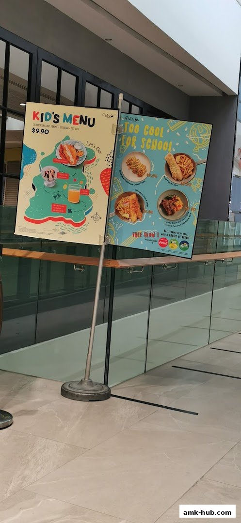Two signs displaying kids' menus from Fish Co. with food and drink options.