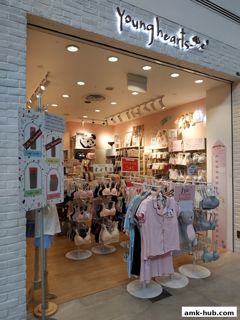 The entrance of a Young Hearts lingerie shop displaying bras, pajamas, and promotional signs.