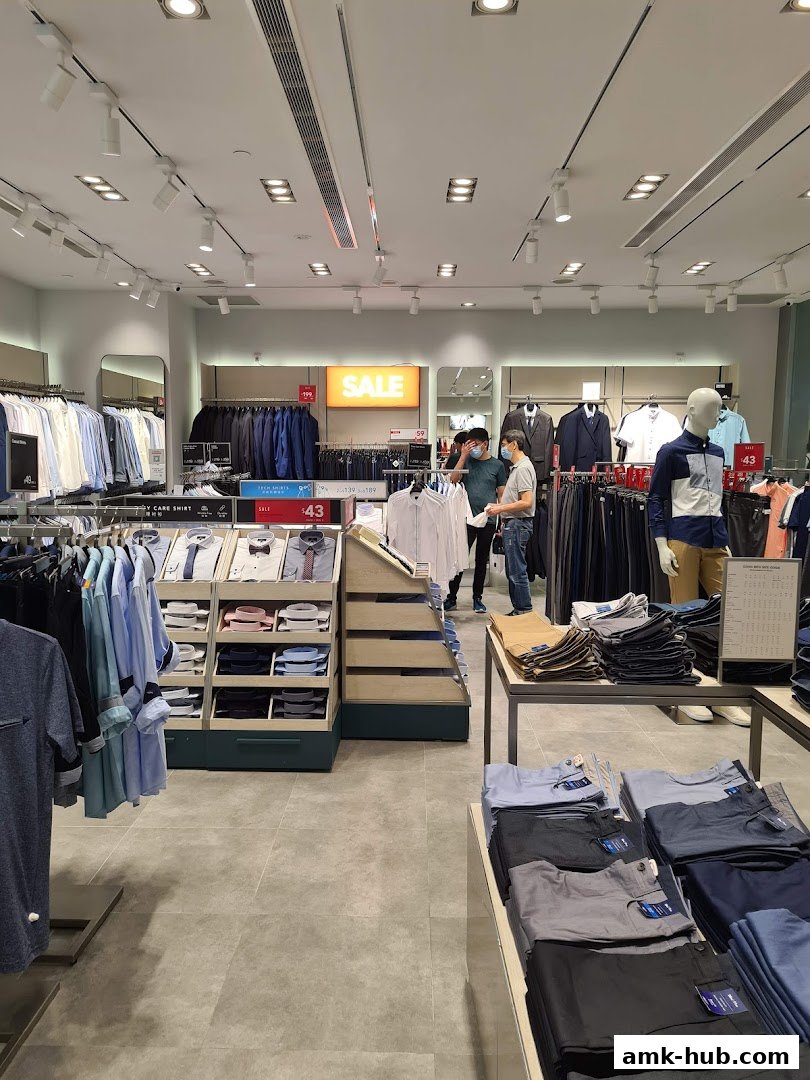 Interior view of a G2000 store showcasing men's clothing and a sale sign.