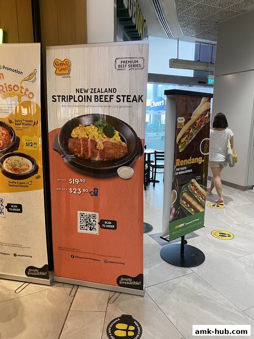 Banners advertising Pepper Lunch's New Zealand Striploin Beef Steak and other dishes, with a Subway banner visible.
