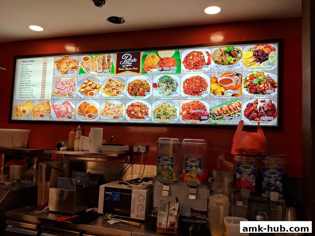 A brightly lit menu board displaying various Indian Muslim food items with enticing images.