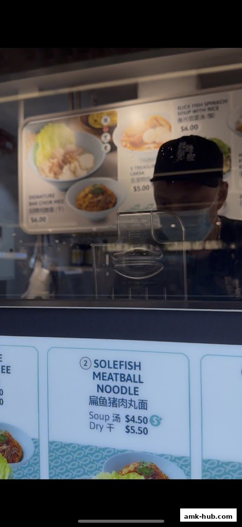 A menu board displays various noodle and soup dishes with prices.