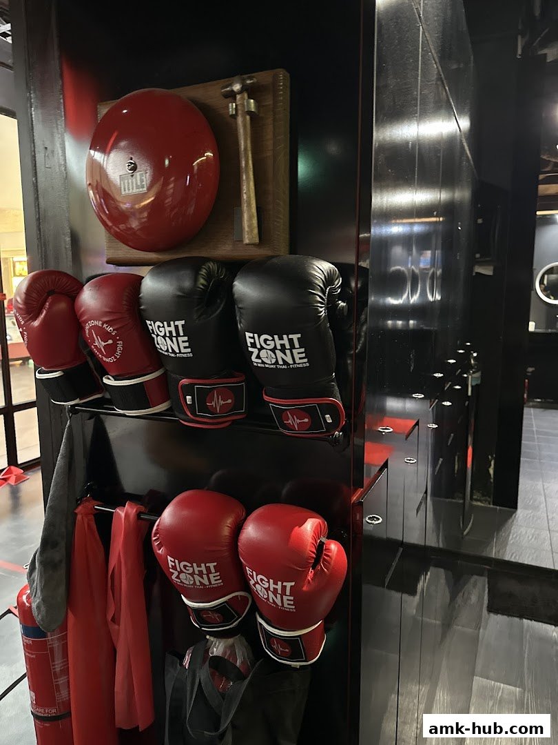 Boxing gloves and training equipment displayed inside a fight training facility.