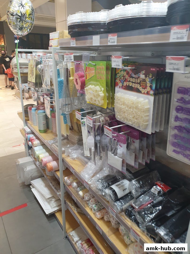 Shelves stocked with baking supplies, including cupcake liners, cookie cutters, and decorating tools.